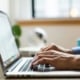 person typing on silver Macbook