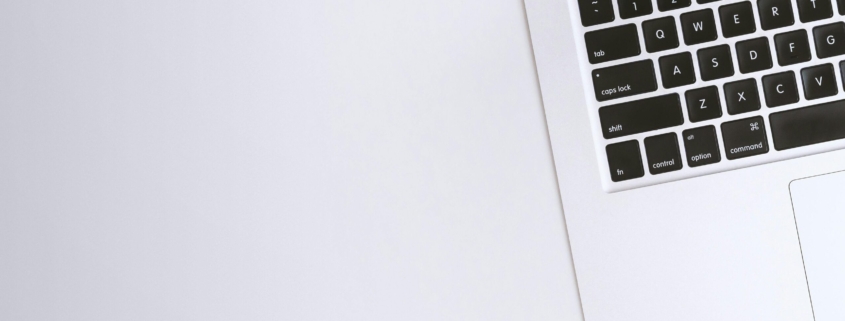 Free Aerial view of a sleek laptop keyboard on a clean, white surface, ideal for tech backgrounds. Stock Photo