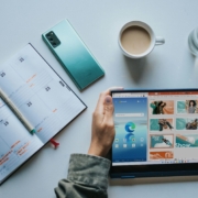 person using Windows 11 computer beside white ceramic mug on white table