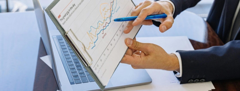 Free Business professionals discussing financial graphs and charts in an office setting. Stock Photo