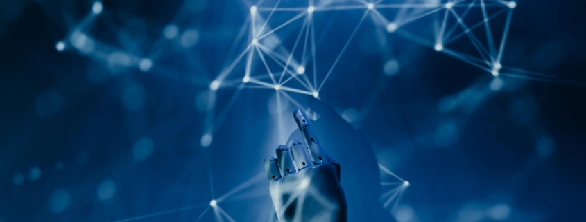 Free A robotic hand reaching into a digital network on a blue background, symbolizing AI technology. Stock Photo