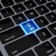 a computer keyboard with a blue light on it